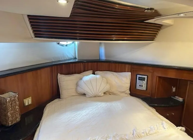 Slide: The Image of Luxurious bedroom interior of 2000 Carver 450 Voyager Pilothouse yacht with elegant wood accents. - 8