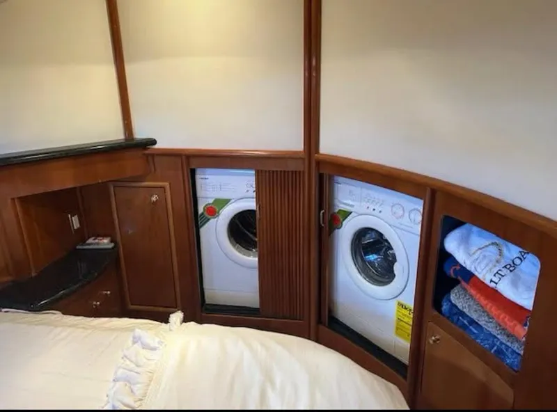 Slide: The Image of Laundry area in 2000 Carver 450 Voyager Pilothouse with washer, dryer, and storage. - 9