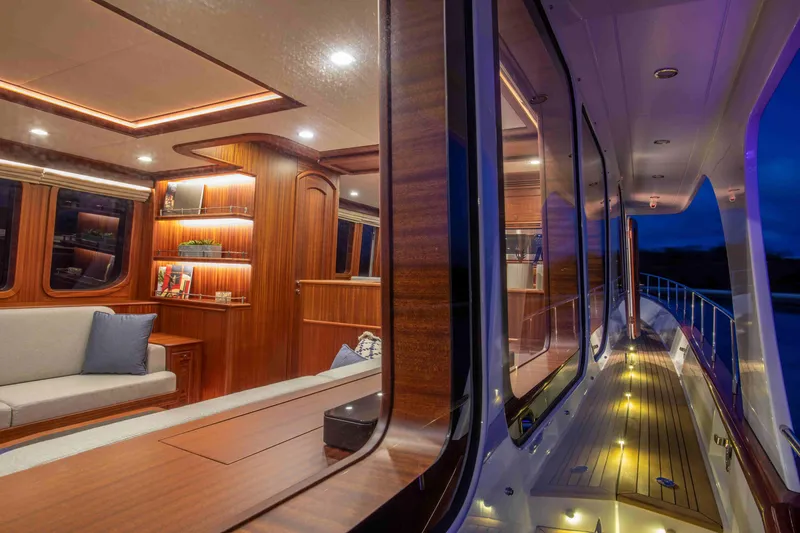 Slide: The Image of Luxurious interior of 2020 Vicem 67 Cruiser yacht with elegant wood finishes and ambient lighting. - 16