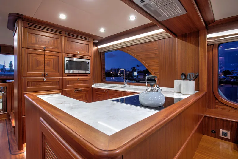 Slide: The Image of Luxurious kitchen interior of 2020 Vicem 67 Cruiser yacht with wood cabinetry and modern appliances. - 18