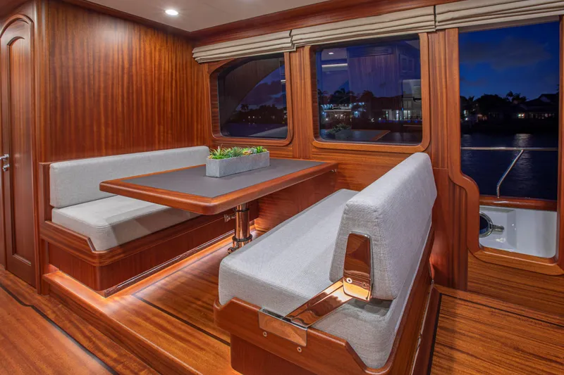 Slide: The Image of Elegant interior of 2020 Vicem 67 Cruiser with wooden dining area and plush seating. - 20