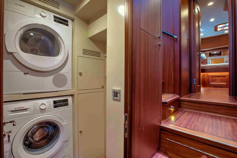 Slide: The Image of Laundry area and wooden staircase inside 2020 Vicem 67 Cruiser yacht. - 26