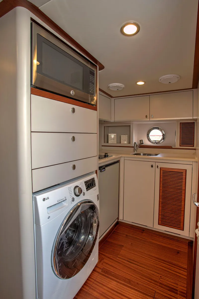 Slide: The Image of Laundry area in 2020 Vicem 67 Cruiser with washer, dryer, and cabinetry. - 31