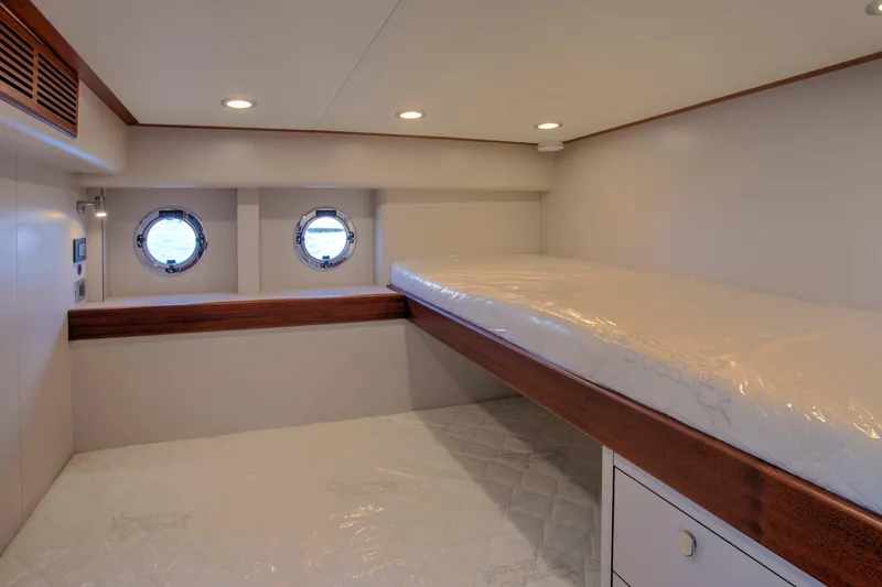 Slide: The Image of Cozy cabin interior of 2020 Vicem 67 Cruiser with porthole windows and bunk bed. - 32