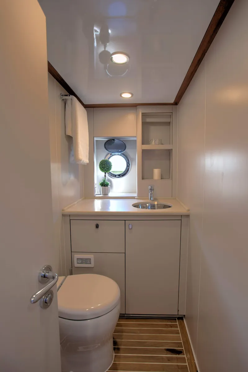 Slide: The Image of Modern bathroom in 2020 Vicem 67 Cruiser yacht with sleek fixtures and wooden flooring. - 33