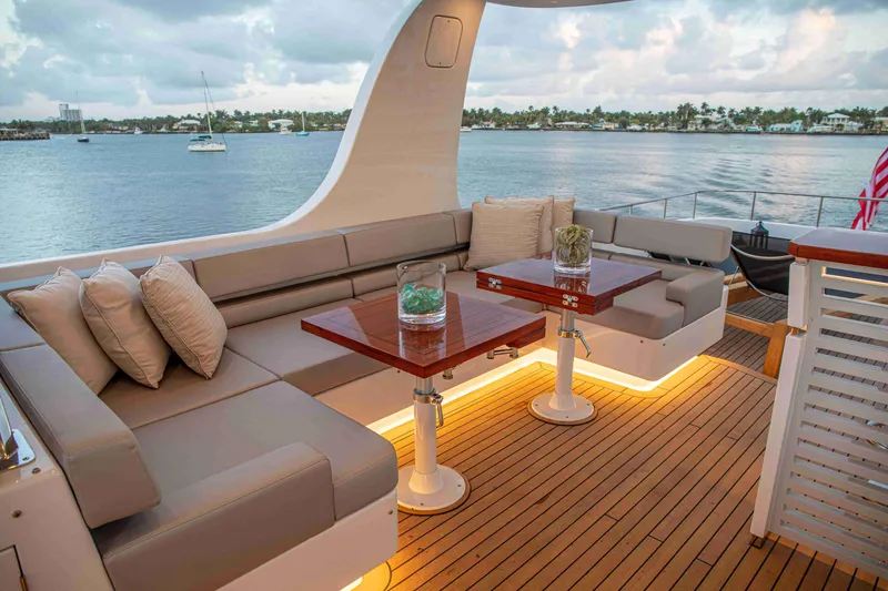 Slide: The Image of Luxurious 2020 Vicem 67 Cruiser yacht deck with elegant seating and scenic waterfront view. - 8