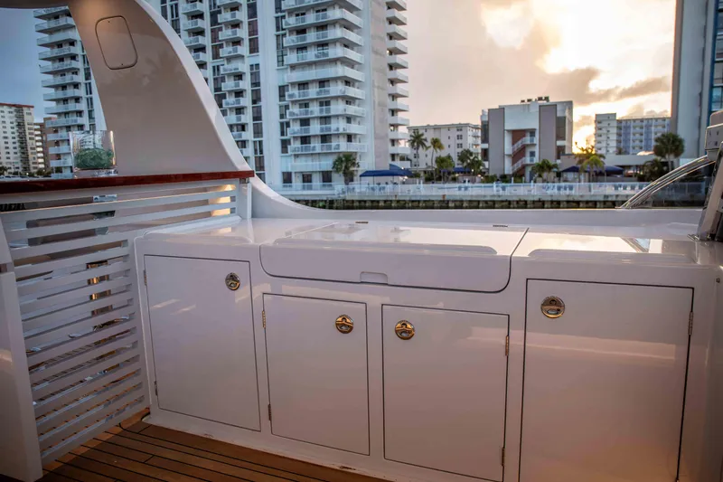 Slide: The Image of Vicem 67 Cruiser 2020 yacht deck with cabinetry, cityscape in background at sunset. - 9