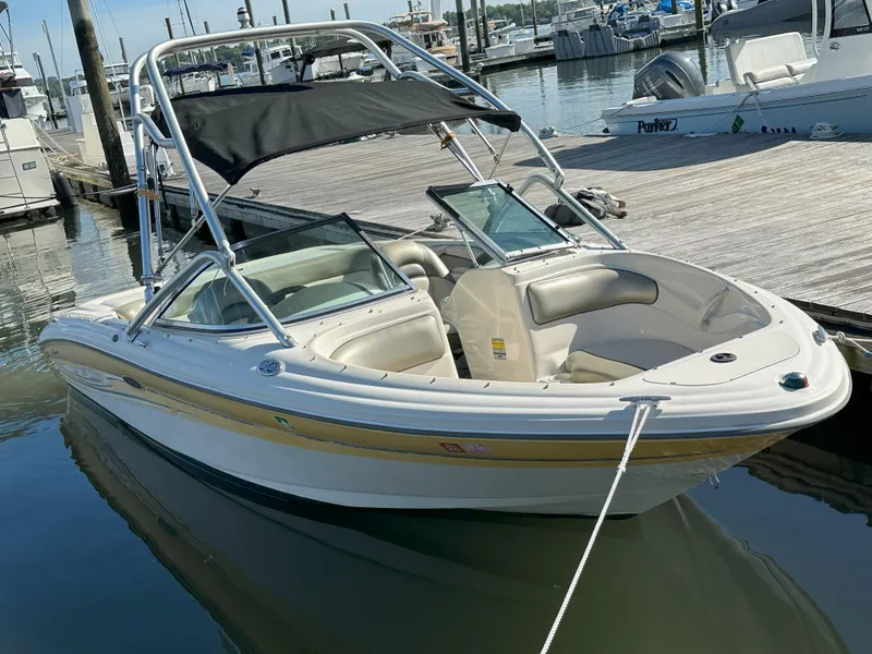 The Image of 2005 Sea Ray 185 Sport boat docked at marina with canopy. - 0