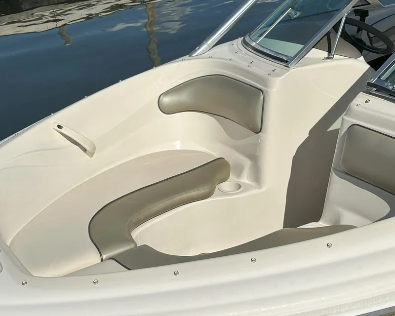 Slide: The Image of 2005 Sea Ray 185 Sport boat interior with beige seating and windshield. - 6