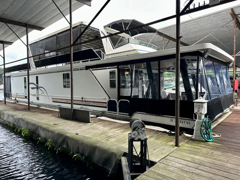 The Image of 2004 Lakeview 16x68 houseboat docked under covered marina. - 0