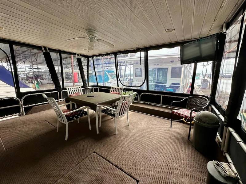 Slide: The Image of Spacious 2004 Lakeview 16x68 houseboat interior with dining area and large windows. - 1