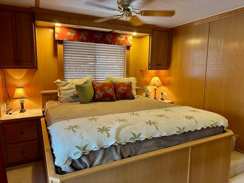 Slide: The Image of Cozy bedroom in 2004 Lakeview 16x68 model with wooden decor and ambient lighting. - 10