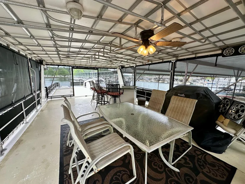 Slide: The Image of Spacious 2004 Lakeview 16x68 houseboat deck with dining area and ceiling fan. - 15