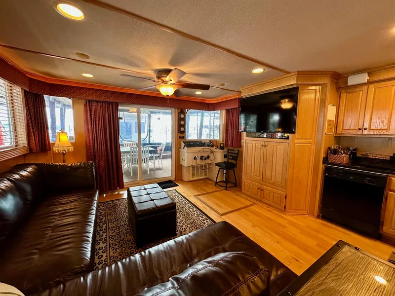 Slide: The Image of Luxurious 2004 Lakeview 16x68 houseboat interior with leather seating, wood accents, and modern amenities. - 3