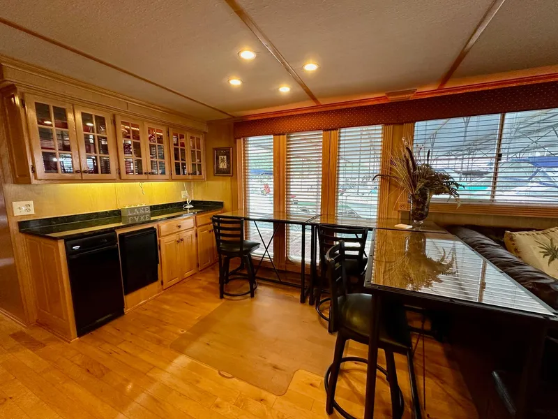 Slide: The Image of Spacious kitchen area in 2004 Lakeview 16x68 houseboat with wooden cabinets and large windows. - 5
