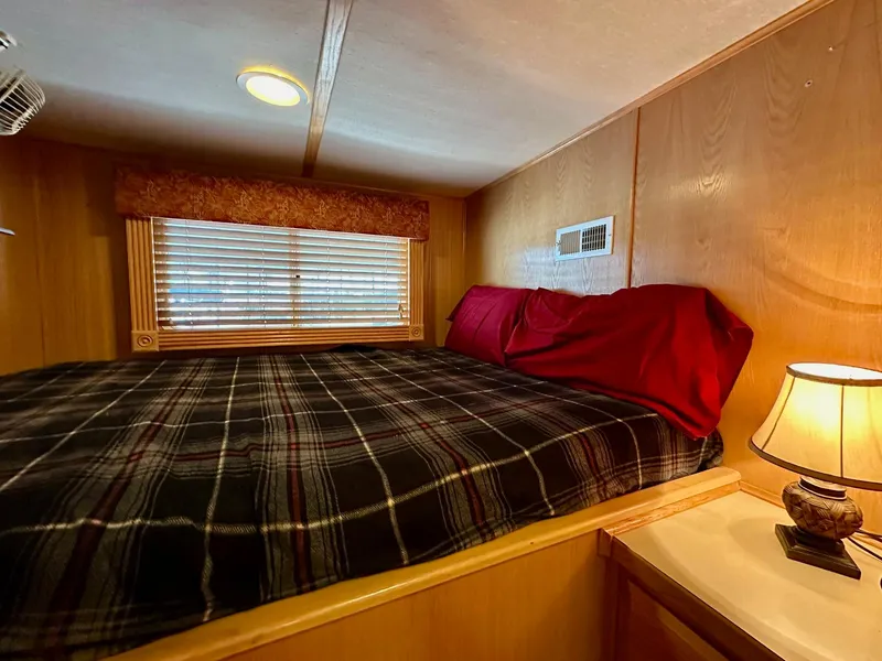 Slide: The Image of Cozy bedroom in 2004 Lakeview 16x68 houseboat with plaid bedding and warm lighting. - 6