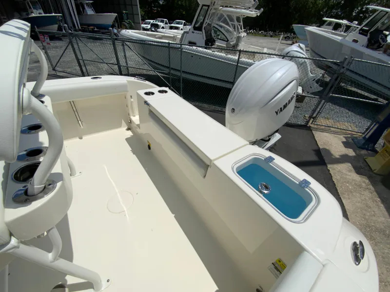 Slide: The Image of 2025 Cobia 220 Center Console boat with Yamaha engine, featuring spacious deck and storage. - 13