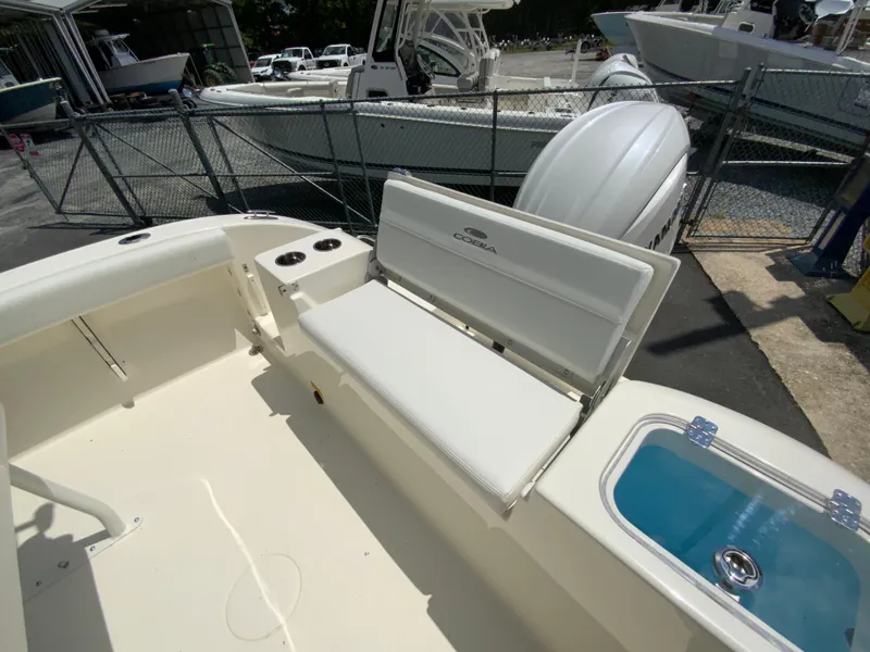 Slide: The Image of 2025 Cobia 220 Center Console boat interior with seating and storage. - 14