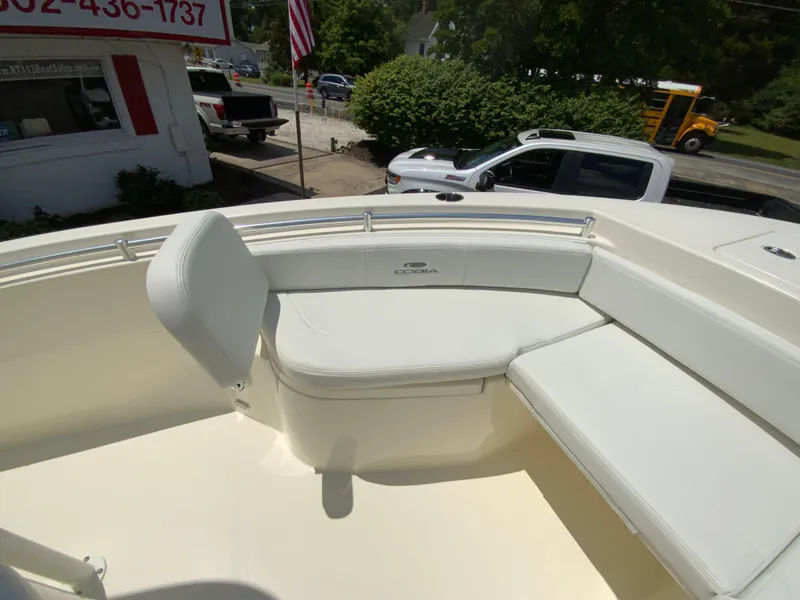 Slide: The Image of 2025 Cobia 220 Center Console boat with white seating and sleek design. - 20