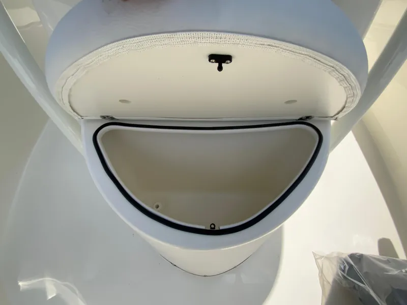 Slide: The Image of 2025 Cobia 220 Center Console storage compartment, open and empty, showcasing interior space. - 23