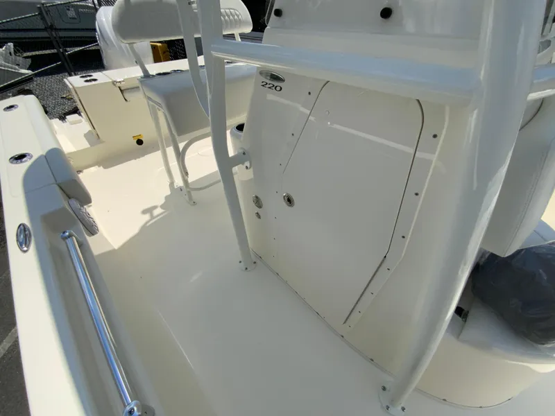 Slide: The Image of 2025 Cobia 220 Center Console boat interior with seating and storage features. - 24