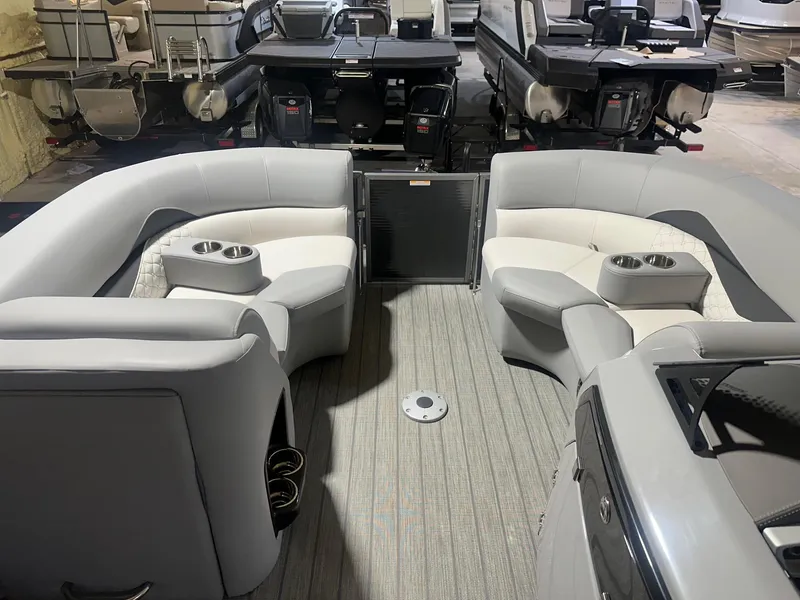 Slide: The Image of 2022 Manitou 23 Encore SL pontoon boat interior with gray seating and cup holders. - 3