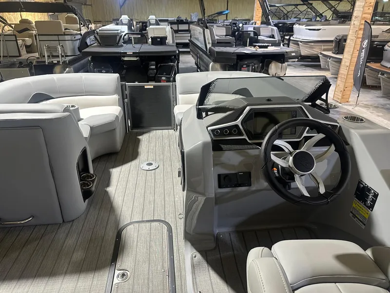 Slide: The Image of 2022 Manitou 23 Encore SL pontoon boat interior with modern helm and seating. - 4