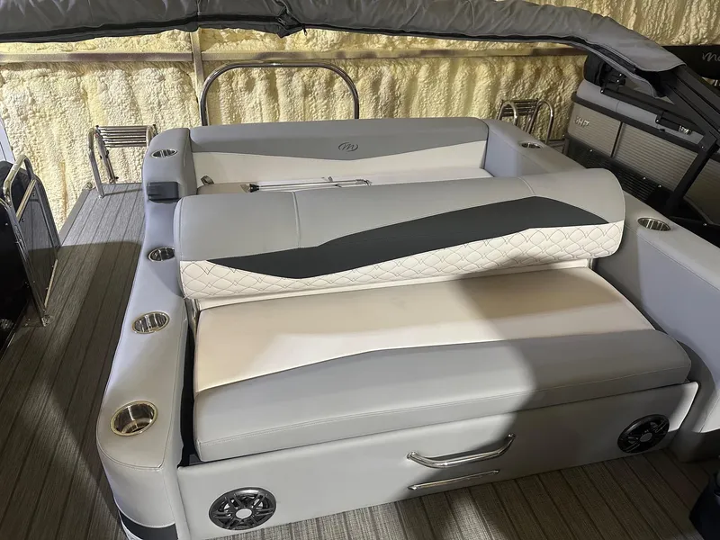 Slide: The Image of 2022 Manitou 23 Encore SL boat interior with gray seating and cup holders. - 5