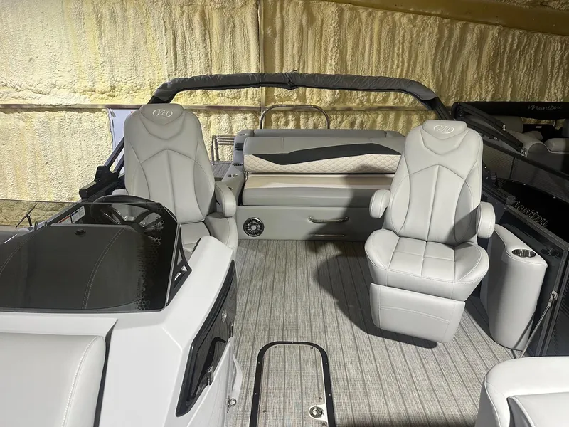Slide: The Image of 2022 Manitou 23 Encore SL boat interior with gray seating and modern design. - 6