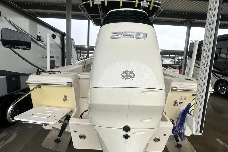 Slide: The Image of Scout 235 Sportfish boat with Suzuki 250 engine, 2024 trailer, rear view. - 10