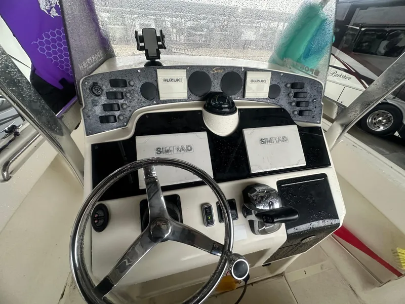 Slide: The Image of Console of 2002 Scout 235 Sportfish with steering wheel and controls. - 4