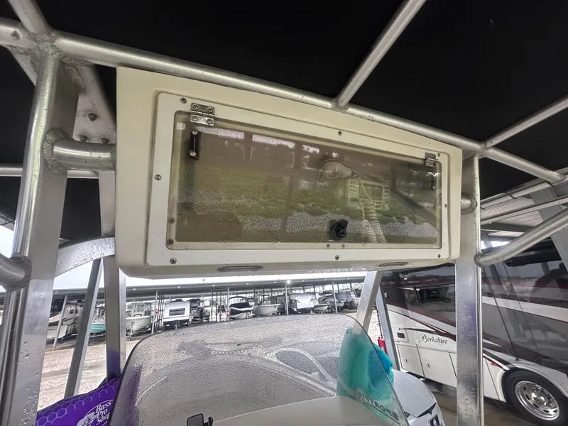 Slide: The Image of T-top storage compartment on a 2002 Scout 235 Sportfish boat, parked in a marina. - 5