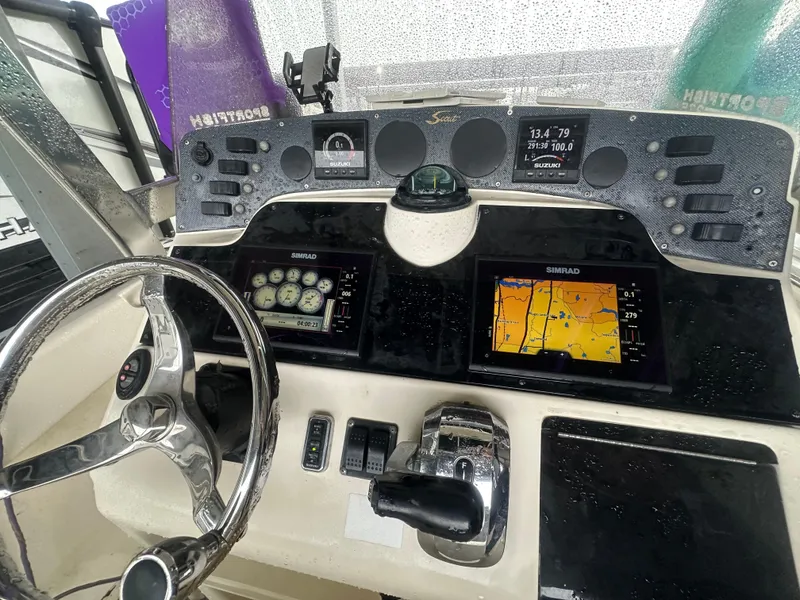 Slide: The Image of Control panel of a 2002 Scout 235 Sportfish boat with navigation displays. - 6