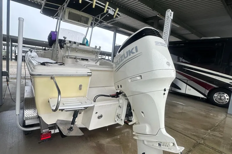 Slide: The Image of Scout 235 Sportfish boat with 2018 Suzuki 250 engine and 2024 trailer, rear view. - 9