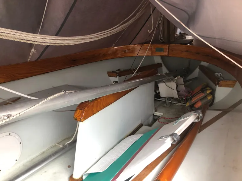 Slide: The Image of 1983 Marshall Sandpiper sailboat interior with wooden trim and rigging. - 3
