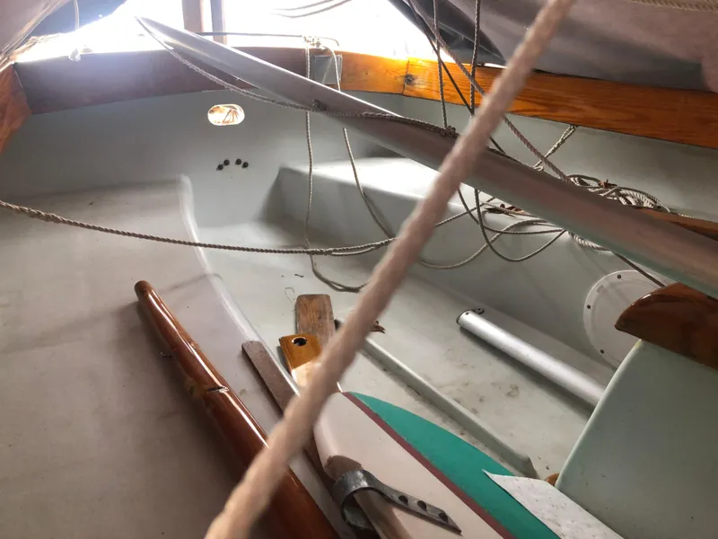 Slide: The Image of 1983 Marshall Sandpiper sailboat interior with ropes and wooden elements. - 4