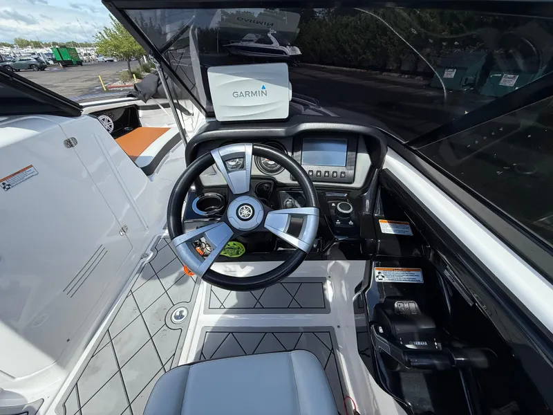 Slide: The Image of 2016 Yamaha AR240 boat cockpit with Garmin navigation system and modern steering controls. - 18