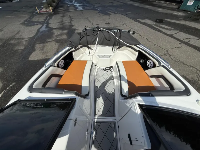 Slide: The Image of 2016 Yamaha Boats AR240 with orange seating, viewed from above on a paved surface. - 19