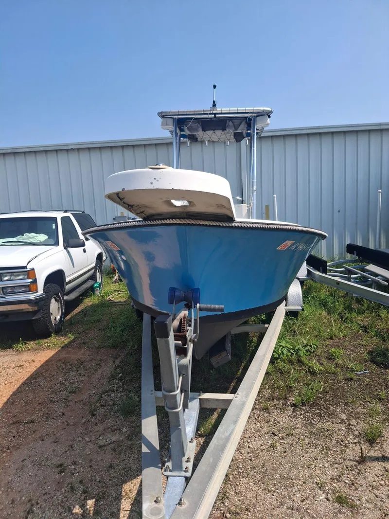 Slide: The Image of 1976 Shamrock Open Motorboat on trailer, parked outdoors near a white vehicle. - 12