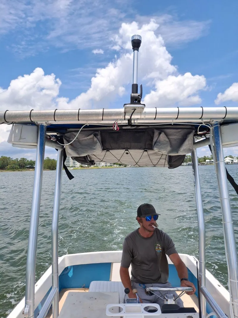 Slide: The Image of Man steering 1976 Shamrock Open Motorboat on a sunny day. - 2
