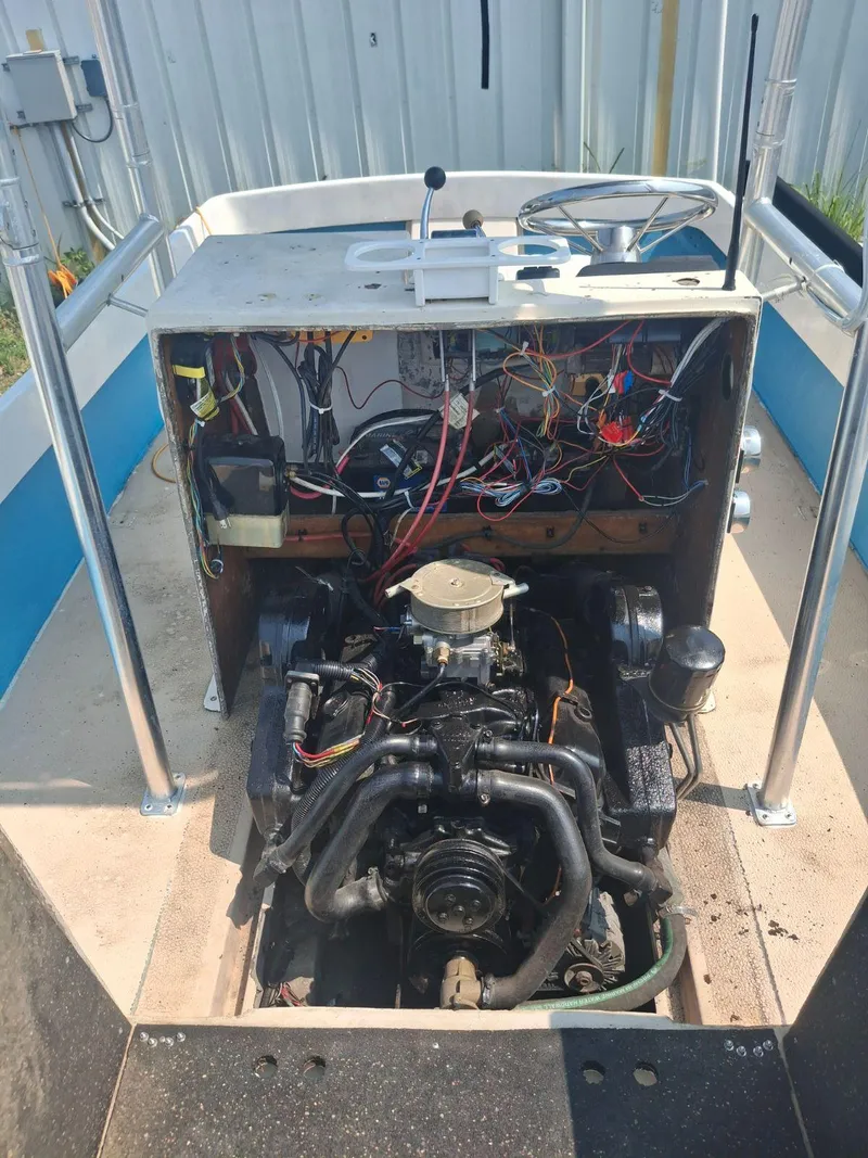 Slide: The Image of 1976 Shamrock Open Motorboat engine compartment with exposed wiring and components. - 5
