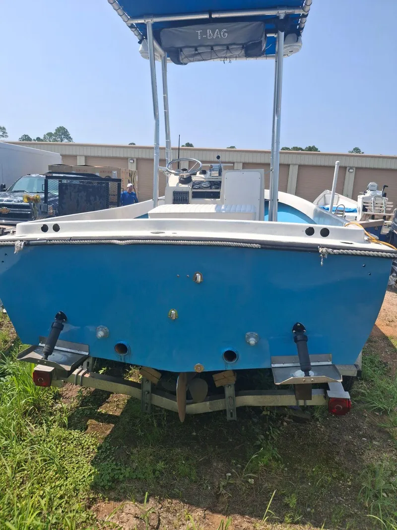 Slide: The Image of 1976 Shamrock Open Motorboat, blue hull, parked outdoors, rear view. - 8