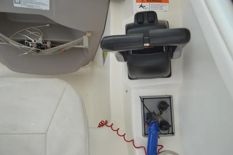 Slide: The Image of 2005 Wellcraft 252 Coastal boat controls and dashboard with throttle and safety features. - 21
