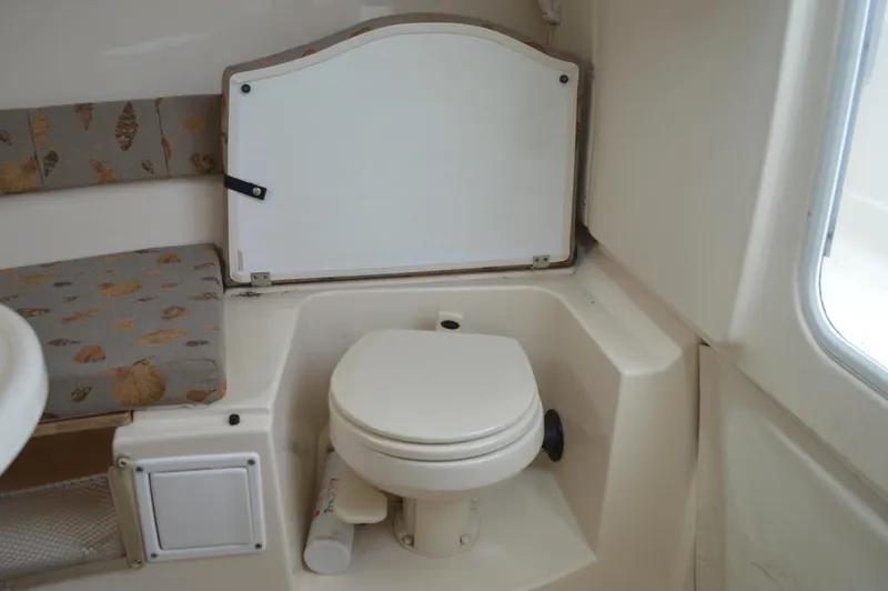 Slide: The Image of 2005 Wellcraft 252 Coastal boat interior with compact marine toilet. - 45