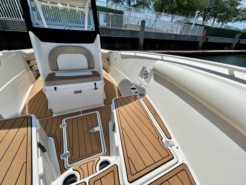 Slide: The Image of 2013 Sailfish 270 CC boat interior with teak flooring and seating. - 11