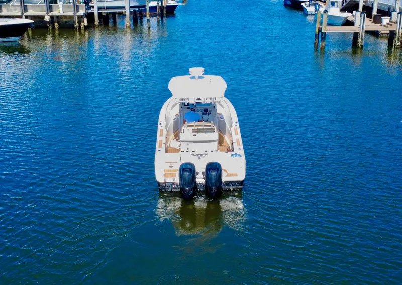 Slide: The Image of 2013 Sailfish 270 CC boat on water, rear view, docked in marina. - 2