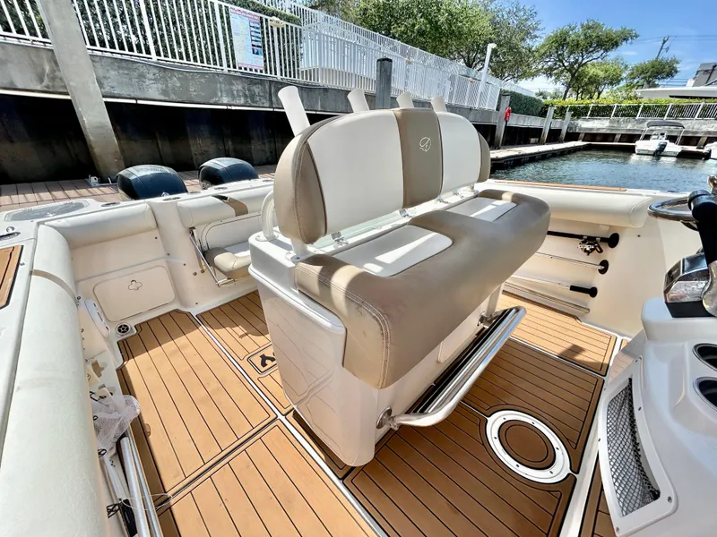 Slide: The Image of 2013 Sailfish 270 CC boat interior with beige seating and teak flooring. - 23