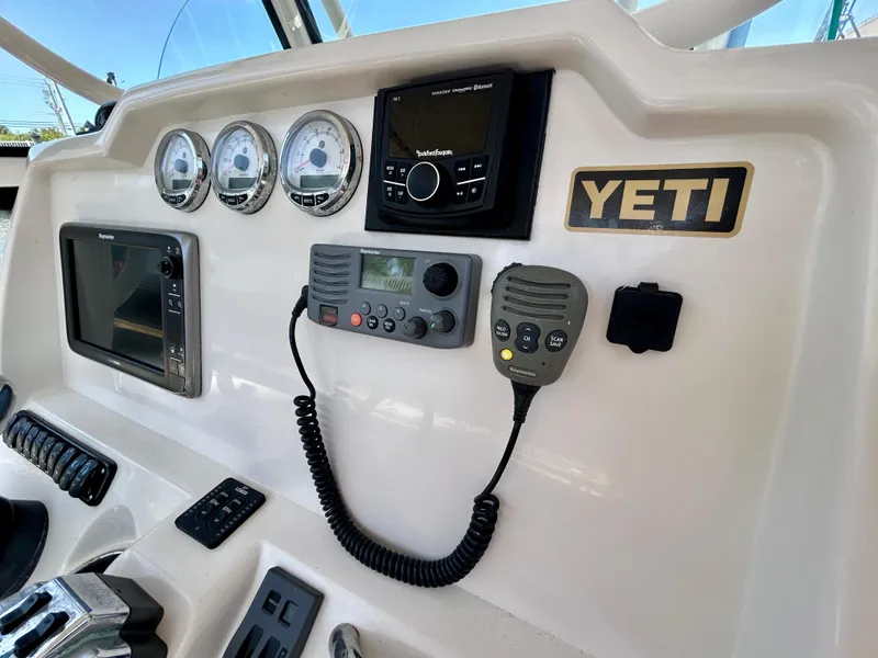 Slide: The Image of Dashboard of a 2013 Sailfish 270 CC boat with navigation and communication equipment. - 27