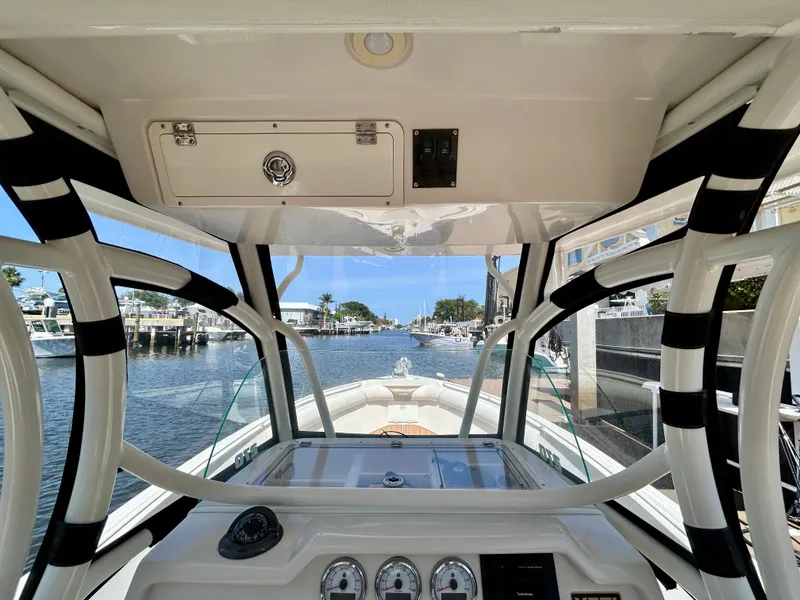 Slide: The Image of Interior view of 2013 Sailfish 270 CC boat cockpit with clear waterfront scenery. - 30