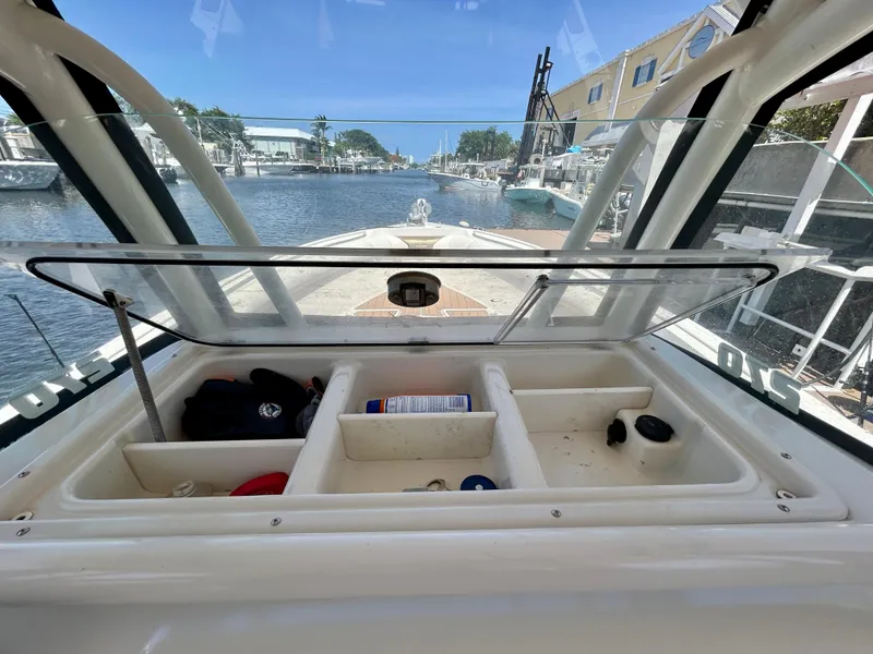 Slide: The Image of Open storage compartment on 2013 Sailfish 270 CC boat, docked in a marina. - 31